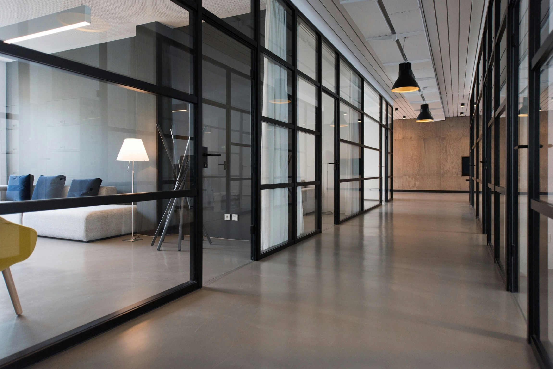 Office hallway with glass-walled meeting rooms